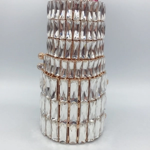 Close-up of rose gold lipstick clutch evening bag featuring dense crystal rhinestone layers