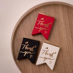 Foil-stamped 'Thank You' swallowtail gift tags in red, black, and white colors