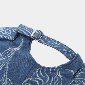 Macro view of blue washed denim brimless docker hat with adjustable metal buckle clasp