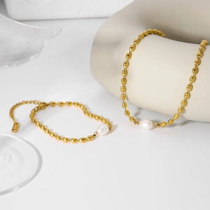 Elegant gold oval bead bracelet and necklace set with a natural white freshwater pearl