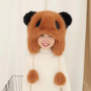 Detail view of children's brown panda winter plush hat with earflaps and pompom ties