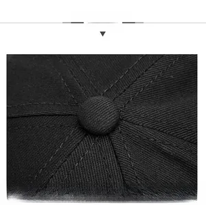 Close-up of black cotton baseball cap top showing neat stitching and fabric button