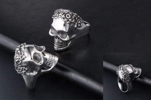 Macro view of detailed silver skull ring with ornate floral carvings on the band