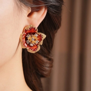 Vintage gold-plated flower stud earrings with red enamel and shimmering crystals