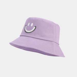 Close-up of lilac cotton bucket hat featuring a smiley face print and fine stitching