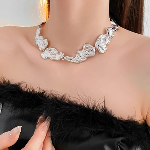 Detailed view of silver irregular lava necklace with liquid metal texture on a model