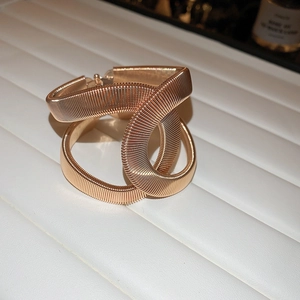 Detailed view of rose gold interwoven cuff bracelet with fine coiled wire texture