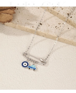 Macro detail of S925 silver paperclip necklace with enamel evil eye and car charms