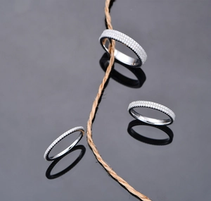 Detailed macro view of three 925 sterling silver eternity rings with triple-row pavé diamonds