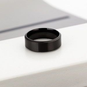 Detailed view of 8mm matte black titanium steel ring with double beveled edges