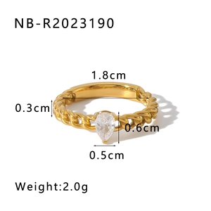 Close-up of a 18k gold plated chain textured ring with a pear-shaped cubic zirconia stone
