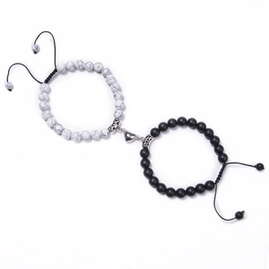 Macro shot of black and white turquoise bead bracelets with heart-shaped magnetic clasp