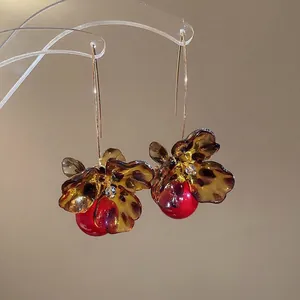 Vintage acrylic flower earrings with leopard print, red pearl drop, and gold ear hooks