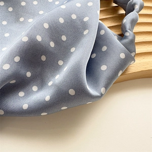Blue satin hair scarf with white polka dots featuring smooth silk texture and elastic band