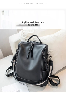 Detail of black leather backpack featuring long tassel zippers and striped fabric straps