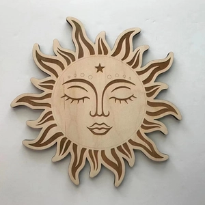 Detail of wooden sun face wall decor featuring laser-engraved lines in bohemian style