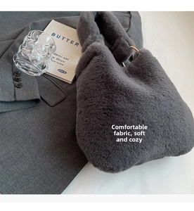 Detail of grey faux fur handbag showing plush texture and metallic ring handle connectors
