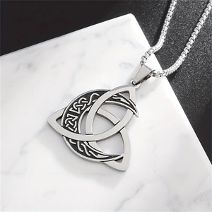 Silver Viking Triquetra pendant necklace with black enamel and lunar phases on marble