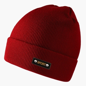Detail of red knit beanie with leather SPORT patch and metal rivets for winter