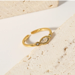 Detailed macro view of gold adjustable ring featuring marquise-cut white zircon stone