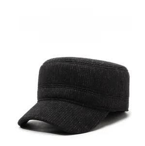 Detail of dark grey wool winter cap featuring warm ear flaps and mountain metal buckle