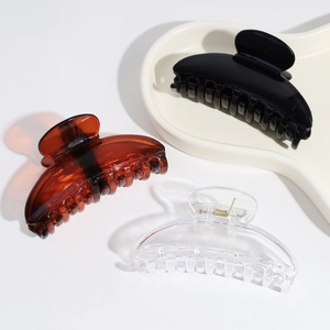 Three classic large hair claws in black, tortoise, and clear colors on white background
