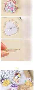 Close-up of acrylic cartoon cat brooch showing digital printing and safety pin back