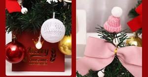 Detail of mini Christmas tree with red gift box base and pink knit hat ornaments