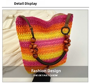 Detail of bohemian rainbow straw tote bag featuring colorful stripes and wooden bead handle