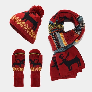 Detail of red Christmas knit set featuring black elk silhouette and snowflake patterns