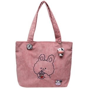 Pink corduroy tote bag detail with rabbit embroidery and cute cow plush pendant