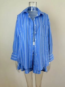 Close-up of blue and white striped shirt collar and pocket details on a casual set
