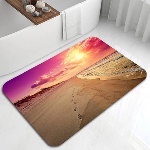 Detail of diatom mud bath mat with sunset beach print placed beside a white bathtub