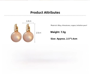 Detail of luxury pearl drop earring with rhinestones on a polished gold finish