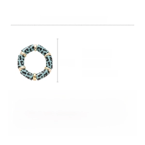 Macro shot of blue leopard print acrylic elastic bracelet with gold metal beads and size specs