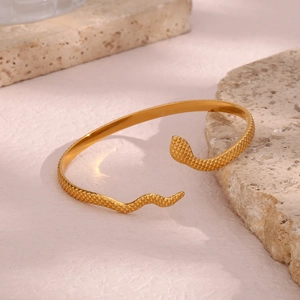 Close-up of golden 18K gold plated snake bracelet showing detailed scale texture