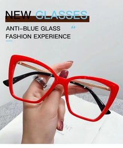 Detail of red cat-eye blue light blocking glasses featuring gold glitter temples