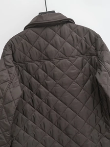 Detail view of the diamond-quilted back on this dark coffee oversized quilted cotton jacket