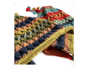 Detail of colorful striped knit hat with soft wool texture and cr brand label detail