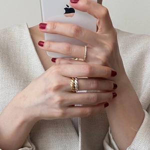 Detailed view of layered 925 sterling silver rings with twisted rope and pavé crystals