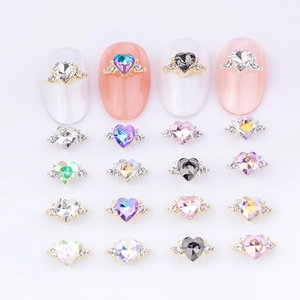 Charming heart-shaped nail art charms with side stones on golden and silver alloy bases