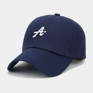 Detailed view of white 3D letter A embroidery on navy blue cotton baseball cap