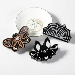 Halloween gothic hair clip set with spider web bat and skull moth designs on white tray