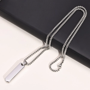 Detail of silver geometric rectangular pendant on a sleek metal box chain for men