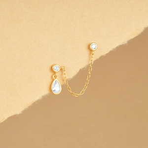 Detailed close-up of gold S925 silver chain earrings with sparkling zircon pendants