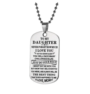 Macro shot of stainless steel dog tag necklace with engraved message from mom to daughter