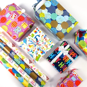Colorful birthday gift wrapping paper set with balloon and dinosaur prints on white background