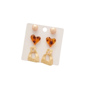 Three-piece earring set with leopard print hearts and gold geometric studs on a white card