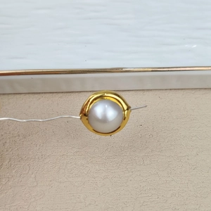 Macro shot of natural freshwater pearl with gold plated edge for DIY jewelry making