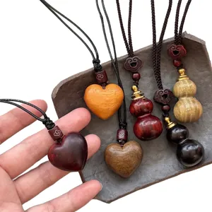 Vintage wooden heart and gourd pendant necklace with woven cord for a folk style look